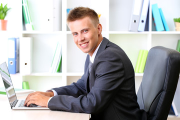 Portrait of young businessman working in office