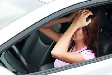 Sad woman in a car