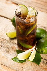 cocktail with cola ice cubes and lime