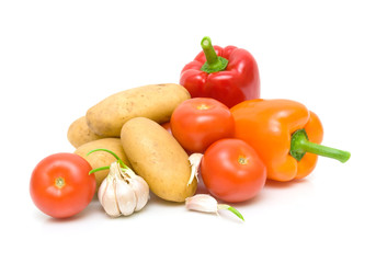 potatoes, tomatoes, peppers and garlic on a white background clo