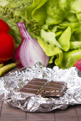 vegetables and chocolate on wood