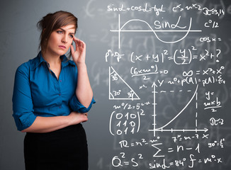 Beautiful school girl thinking about complex mathematical signs