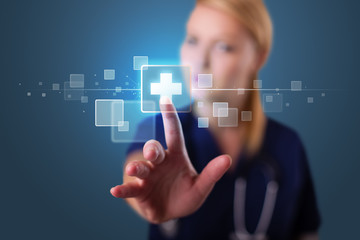 Young nurse pressing modern medical type of buttons