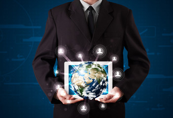 Businessman presenting 3d earth globe in tablet