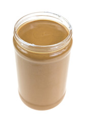 Opened jar of peanut butter on white background