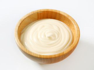 Creamy sauce in wooden bowl