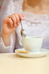 Fototapeta na wymiar Bride and cup of the coffee