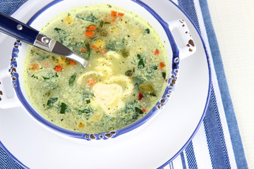 Soup in plate on napkin on table