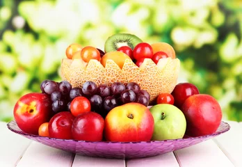 Fotobehang Assortment of juicy fruits on wooden table, on bright © Africa Studio