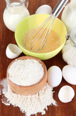 Ingredients for dough on wooden table close-up