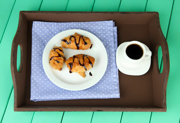 Wooden tray with breakfast, on color wooden background