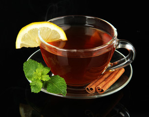Cup of tea with lemon isolated on black