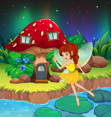 Une fée volant près de la maison aux champignons rouges