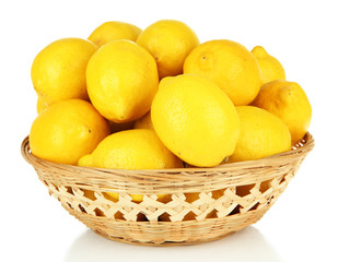 Ripe lemons in wicker basket isolated on white