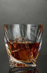 Glass of whiskey, on dark background