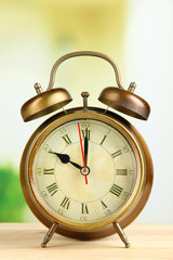 Old alarm clock  on bright background