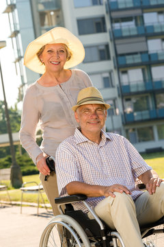 Senior man in wheelchair with wife