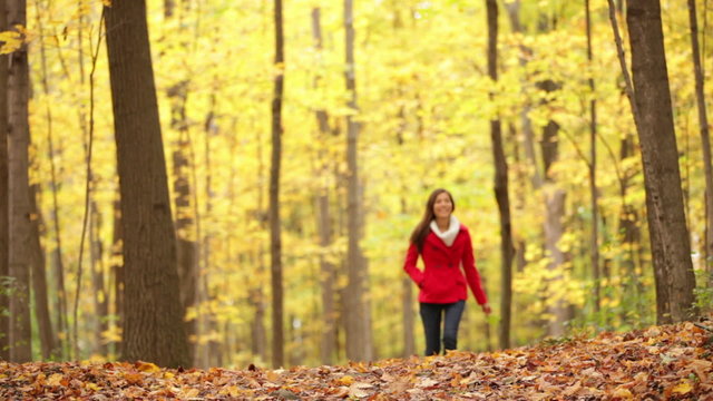 Autumn woman walking in fall forest
