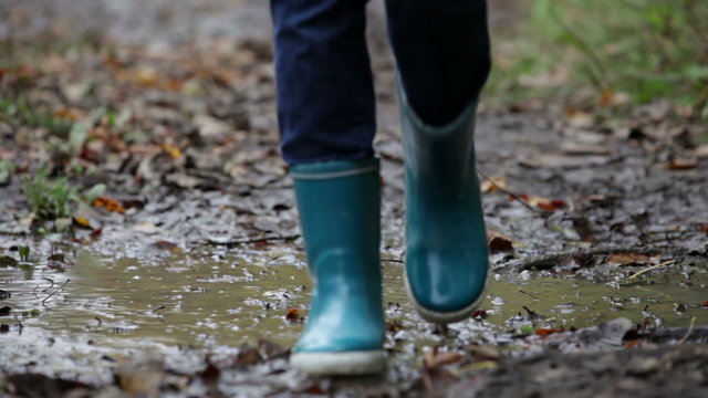 Autumn fall rainboots woman walking in puddle