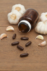 Fototapeta na wymiar Garlic herbal supplement pills , alternative medicine