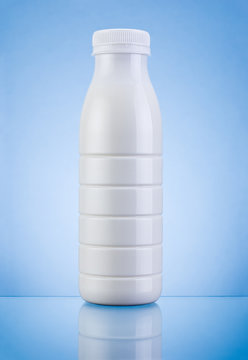 White Plastic bottle of milk on a blue background