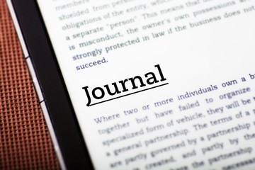 Obraz premium Journal on tablet screen, ebook concept