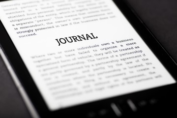 Obraz premium Journal on tablet touchpad, ebook concept