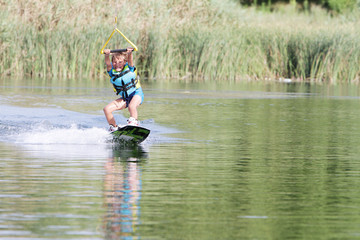young boy wakeboarding