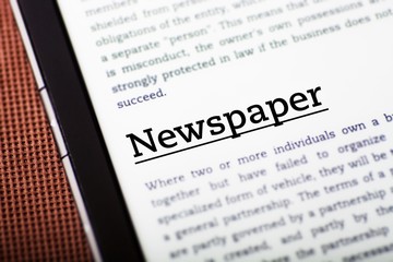 Obraz premium Newspaper on tablet screen, ebook concept