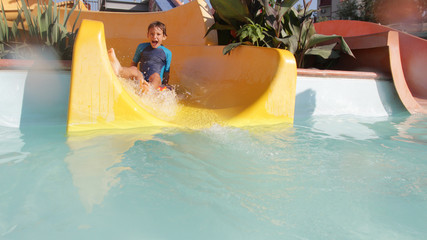 happy child boy having fun in aqua park
