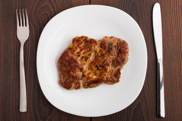 Grilled steak on white plate