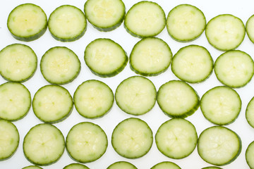Freshly sliced cucumber  isolated on white background