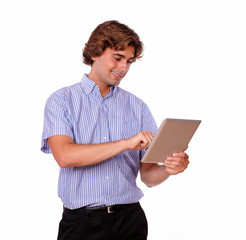 Handsome young man working on his tablet pc