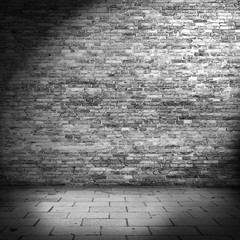 dark brick wall background in basement with beam of light
