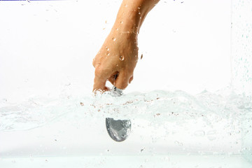Eggs in hand into clear water splash