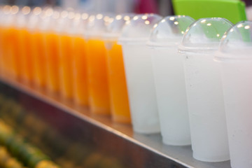 Colorful smoothy fruit juice in plastic glass