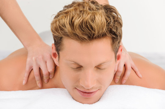 Spa treatment. Close-up of relaxed young men lying on the massag