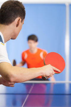 Table tennis game. Two young people playing table tennis