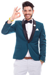 Portrait of a smiling latin man looking and showing you ok sign