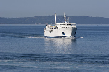 Fototapeta na wymiar The passenger ship is coming in harbor Split from island