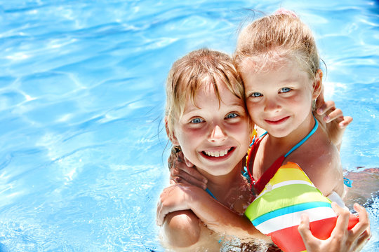 Kids With Armbands In Swimming Pool.