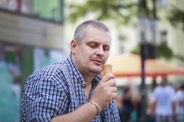 Man with ice cream on a bench