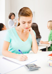 Fototapeta premium student girl with notebook and calculator