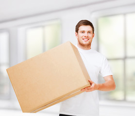 smiling man carrying carton box