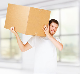 smiling man carrying carton box