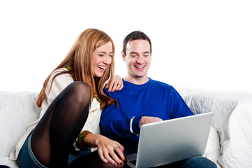 Young couple relaxing on the couch with laptop