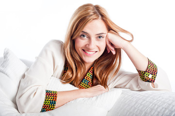 Fototapeta premium Young woman smiling and relaxing on a sofa