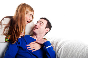 Young couple cuddling and having fun on the sofa