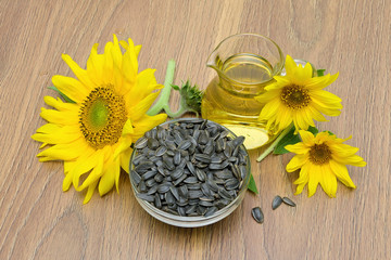 sunflower seeds and flowers, sunflower oil on board