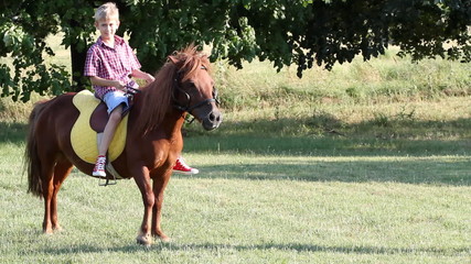 boy riding pony horse